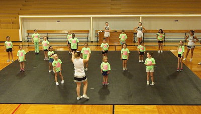 Image: Varsity cheer captain, Taylor Turner, oversees the next cheer routine by the campers.