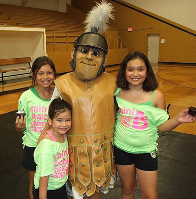 Image: Family photo plus one. On the left, Abbie Alaniz of Midland participated in the 2013 Mini Italy Cheer Camp with cousins Halee Carr, Hannah Carr and with, “George,” the Italy Gladiator mascot.