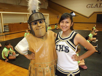 Image: Varsity cheerleader Jessica Garcia poses with Italy’s Gladiator mascot, Noeli Garcia, while the campers warm-up for their big finales.