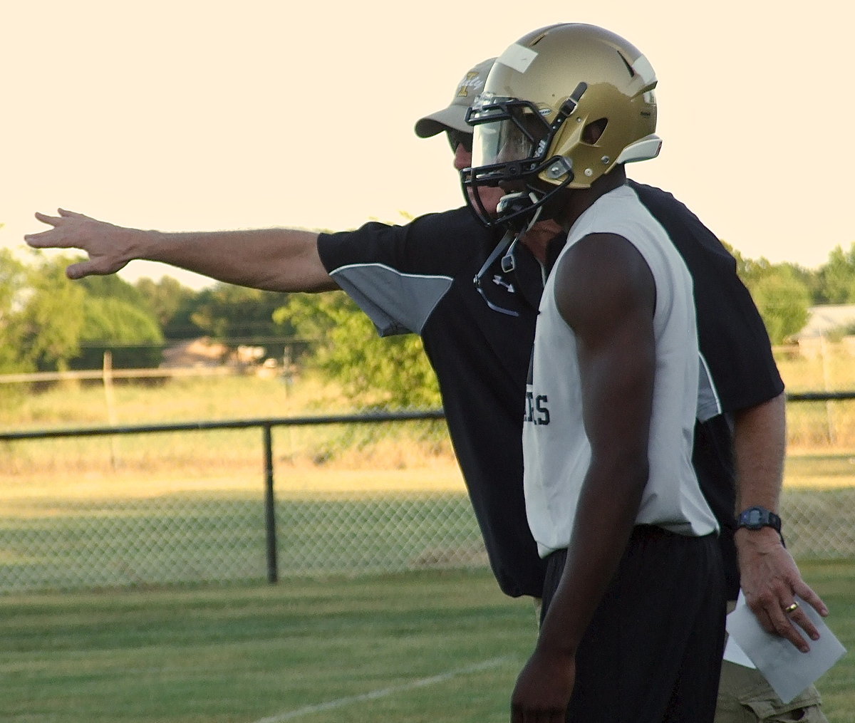 Image: Coach Tindol explains the goal of a play to Gladiator quarterback Tamarcus Sheppard who has transferred from Itasca to Italy for his senior season.