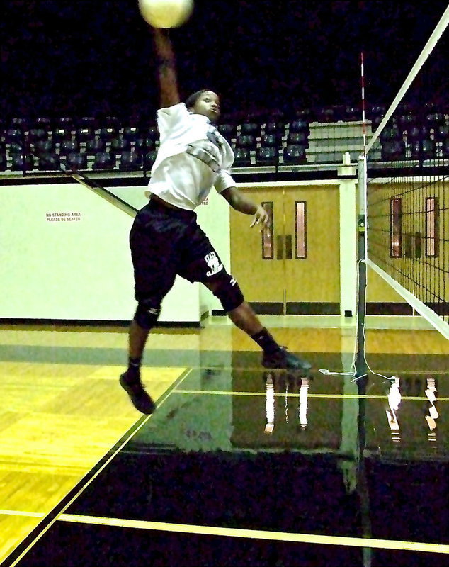 Image: Junior Kortnei Johnson floats above the volleyball net.