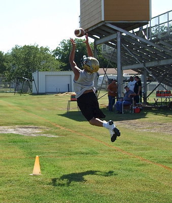 Image: Italy freshman Joe Celis simulates intercepting a pass during the Oskie drill.