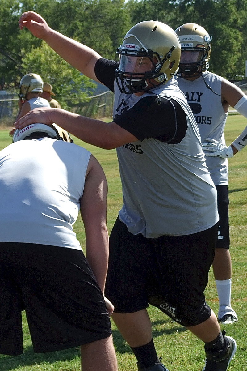 Image: Gladiator junior John Byers practices the swim move during defensive line drills.