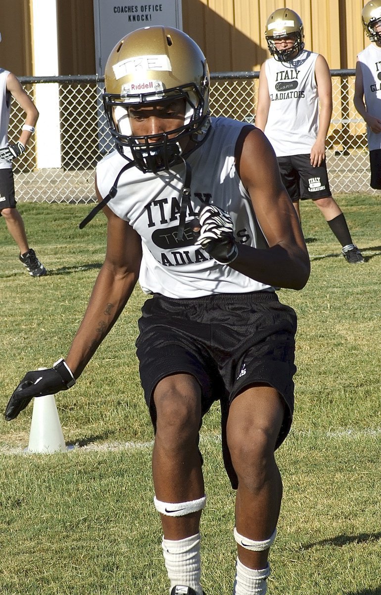 Image: Gladiator skill back Trevon Robertson hustles thru a cone drill during 2-a-day workouts.