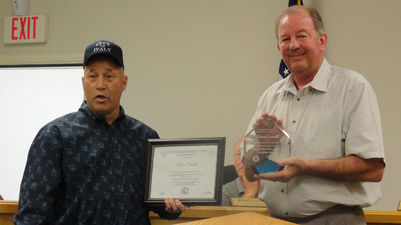 Image: Mayor James Hobbs presents Dean Carrell, public works director, with a glass plaque and certificate from Texas A&amp;M University naming him a Certified Water Professional.