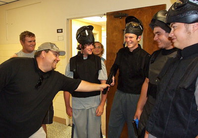 Image: Officer Eric Tolliver requests a loud and noisy gunman that will likely be shot down by the officers during a training scenario. The student volunteers elect teammate Cody Boyd.