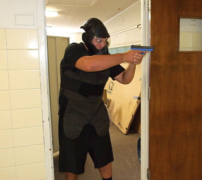 Image: Italy HS senior Kevin Roldan takes aim at officers during a training scenario to help local law enforcement be better prepared in case the school was actually under siege by gunmen.