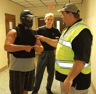 Image: Italy Police Officer Eric Tolliver directs Italy HS juniors Colin Newman and Cody Boyd as to their roles they will each play during the upcoming training scenario.