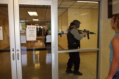 Image: STOP! Police Training In Progress…DO NOT ENTER! Shad Newman obeys the warning signs as Italy Police Officers run thru a training scenario with guns drawn this past Saturday inside Italy High School.