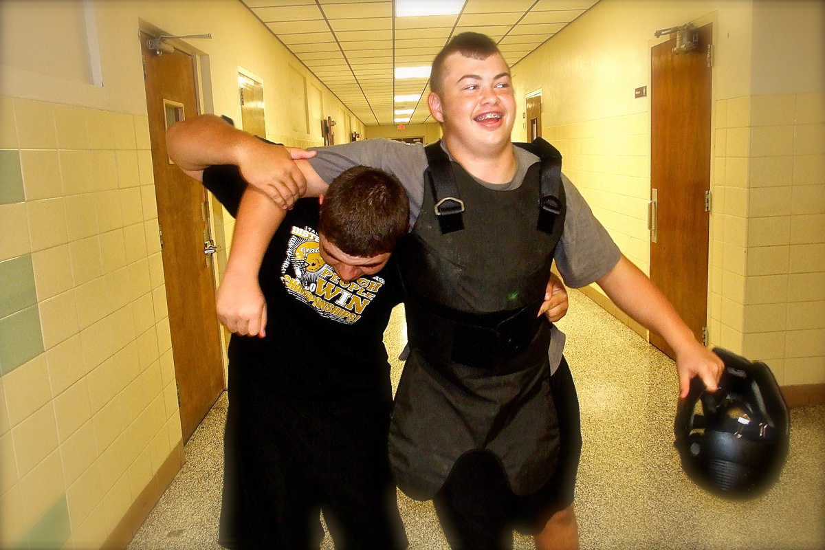 Image: Kevin Roldan helps fellow student volunteer Zain Byers to his feet after Byers simulated being shot down by police officers during a rescue exercise with a Response To Active Shooter Training – School Based drill conducted by the Italy Police Department inside Italy High School.