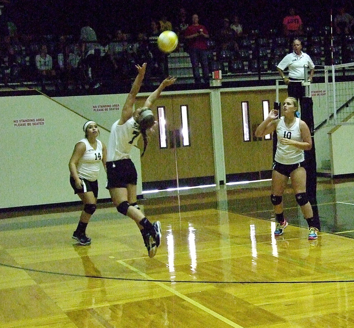 Image: Setter Bailey Eubank(7) covers the court to setup her teammates Monserrat Figueroa(14) and Madison Washington(10).