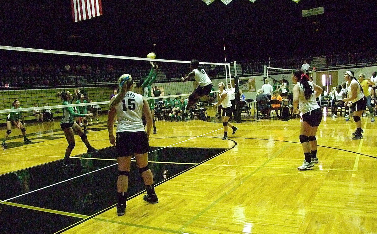 Image: Gaining altitude to spike the point is Italy’s high-flyer Kortnei Johnson(3).