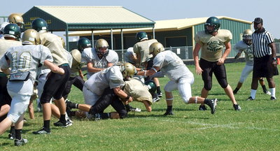 Image: Italy defensive tackle John Byers(72) drives an Eagle runner into the ground as Bailey Walton(99) and Coby Bland(44) close on the play.