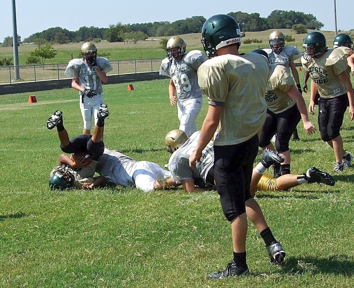 Image: With Valley Mills desperate to put points on the board and trying to open their offensive play book, Italy’s Zain Byers(60) closes the door on an Eagle runner and slams him into the turf.