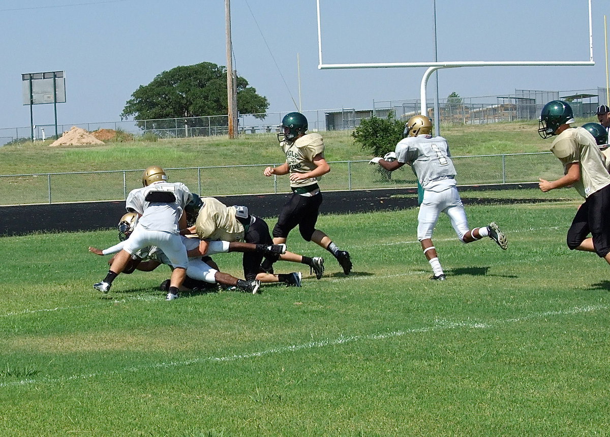 Image: Tamarcus Sheppard(8) gets downfield blocking help from Hunter Merimon(25) and Trevon Robertson(1) to help their quarterback dive across the goal line for an Italy touchdown.