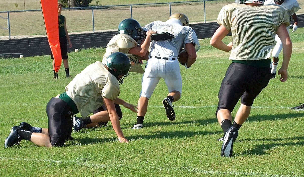 Image: Senior Gladiator Shad Newman(4) catches a pass and then splits two Eagle tacklers for extra yards.