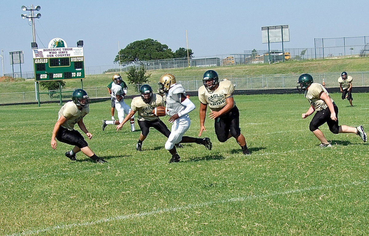 Image: TaMarcus Sheppard(8) slips into the second level of the Eagle defense and then eludes tacklers for more yardage.