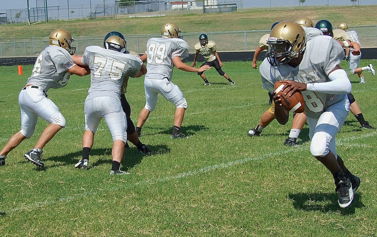 Image: TaMarcus Sheppard(8) thrives behind the blocking of Cody Medrano(66), Kyle Fortenberry(75), Bailey Walton(99) and Kevin Roldan(50).