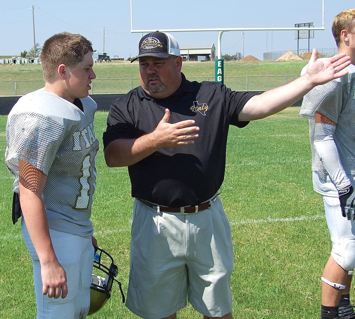 Image: Gladiator assistant coach Wayne Rowe coaches up John Escamilla(10).