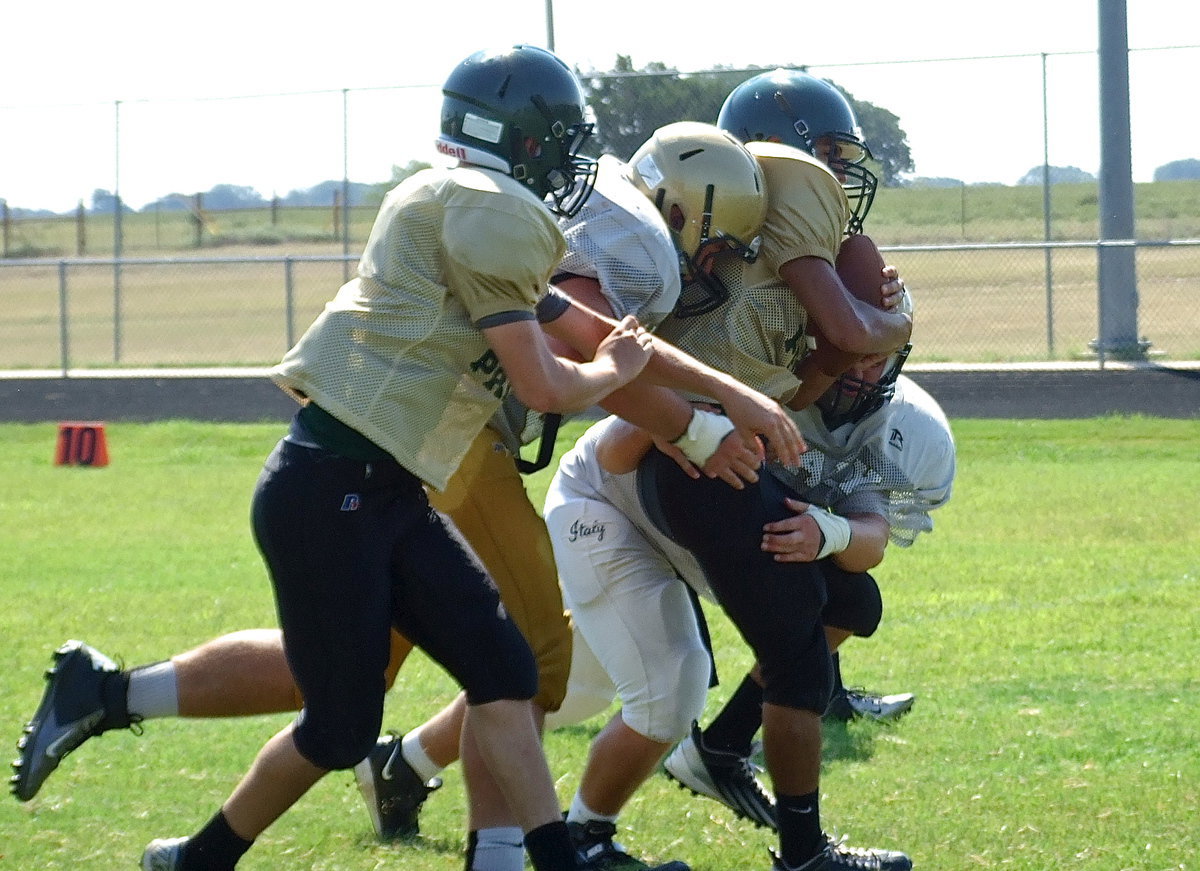 Image: Desperate to score, Valley Mills tries a reverse pitch but All-State defensive end Zain Byers(60) shuts it down with help from Kevin Roldan(50) as the destructive duo drive the unfortunate Eagle back into the turf.