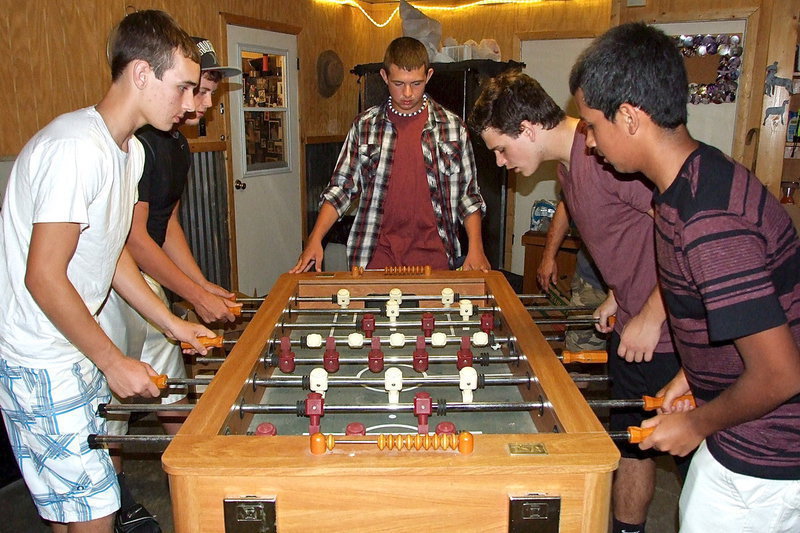 Image: Ryan Connor, Bailey Walton, Austin Crawford, Hunter Merimon and Jorge Galvan try a game of foosball during the Back-to-School Bash hosted by the Lewis Family in honor of the Italy High School student body.