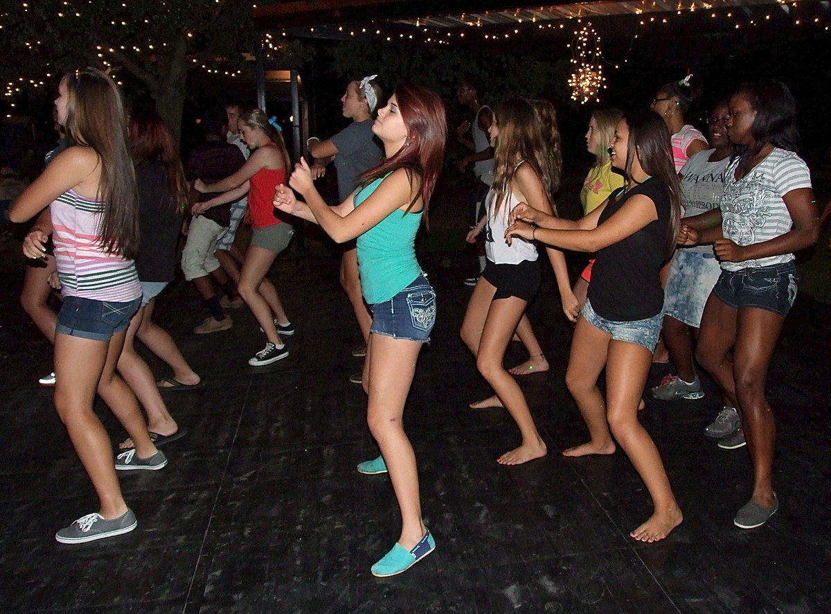 Image: Heavy Grandmaster-J revs up the dance deck as Amber Hooker, Khristian Weeks, Ashlyn Jacinto and Kortnei Johnson lead their lines during the Wobble song by V.I.C.