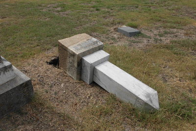 Image: Another historic tombstone toppled over by vandals.
