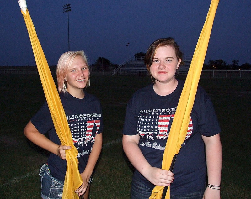 Image: Color guard members Jennifer McDaniel and Kylee Dabney prepare to perform for fans during the band’s on field marching presentation.