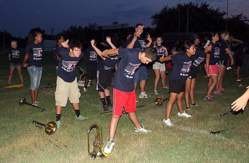 Image: Stretching it out and hamming it up! Zac Mercer and Kelsey Nelson photobomb the warmup routine.