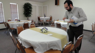 Image: Guilherme Almeida sets the table for lunch at Central Baptist Church.