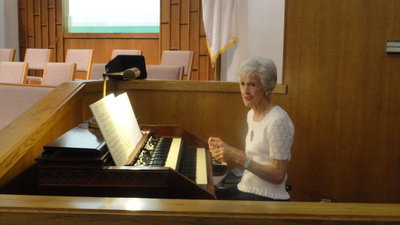 Image: Longtime organist Frances Holley prepares for the morning service.