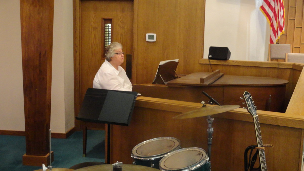 Image: Brenda Wainscott prepares for the morning worship service.