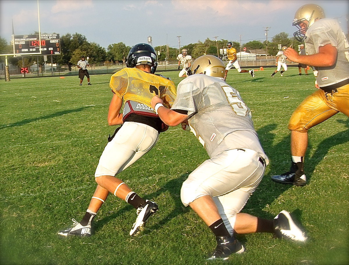 Image: Recording his first of two consecutive sacks is Italy junior John Byers(50).