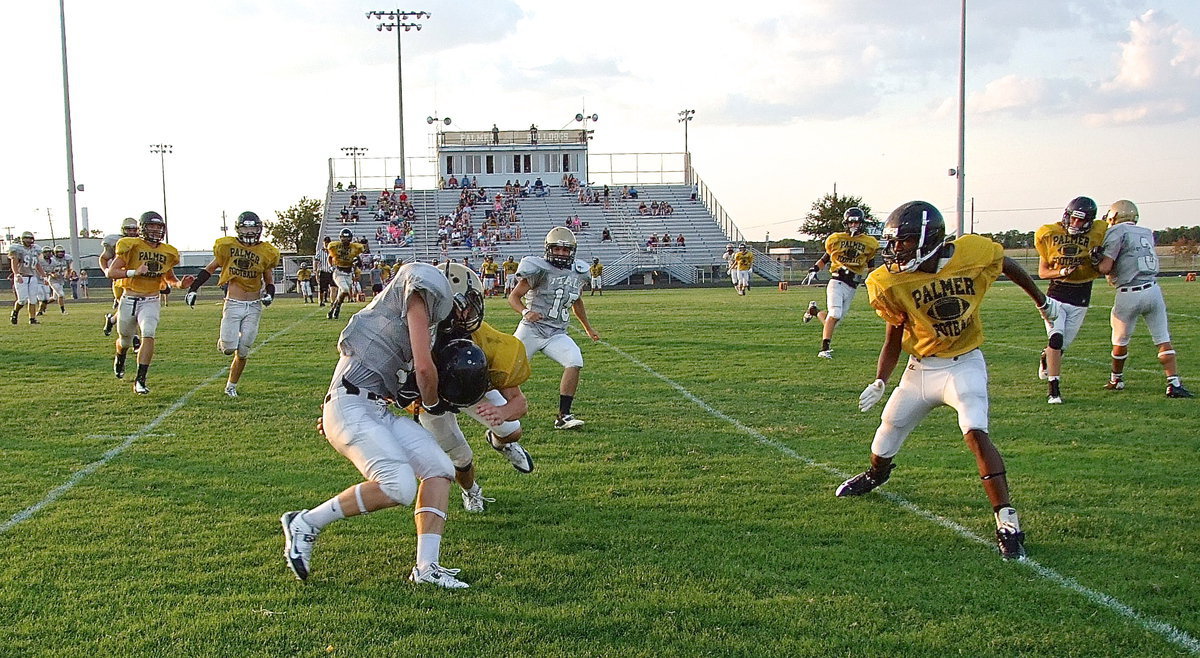 Image: Junior Cody Boyd(11) makes the catch and then powers thru Palmer tacklers for more yards.