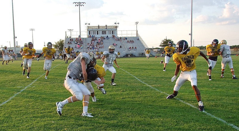 Image: Junior Cody Boyd(11) makes the catch and then powers thru Palmer tacklers for more yards.