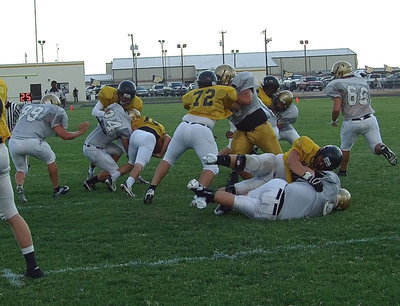 Image: Inside linebacker Shad Newman(24) manages to beat the block and trip up a Palmer running back.
