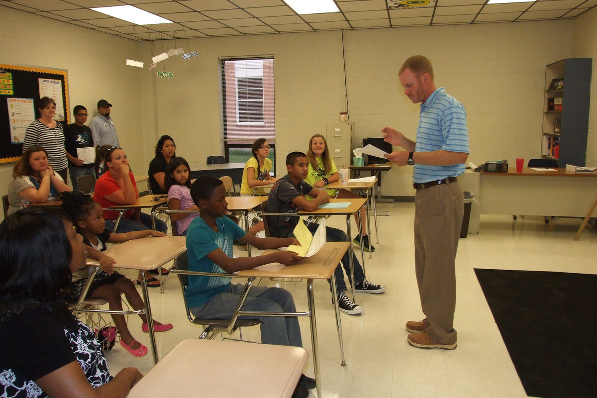 Image: New junior high math teacher, Jon Cady, outlines class requirements for parents and students participating in Meet The Teacher Night at Italy High school. Cady will also be on the coaching staff.