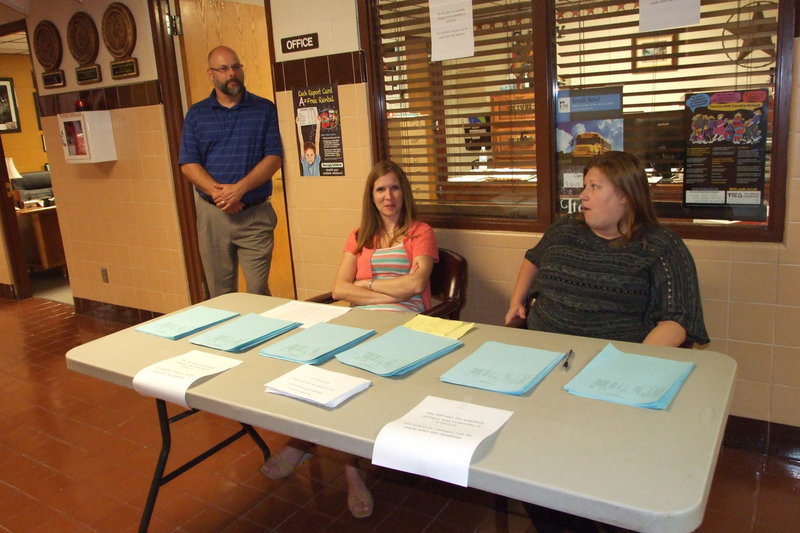 Image: Italy High School principal, Lee Joffre, his wife and librarian, Cassi Joffre and school counselor, Erica Miller, assist parents and students during Meet The Teacher Night.