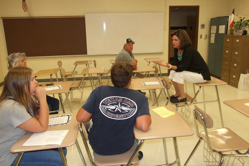 Image: Italy High School teacher, Andrea Windham, meets with parents and students to help everyone be better prepared for the upcoming school year.