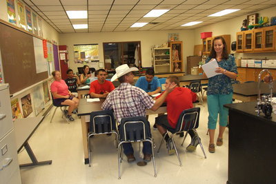 Image: Junior high level science teacher, Lindsey Thompson, hands out her class outline to families participating in Meet The Teacher Night at Italy High school.