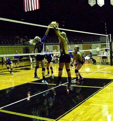 Image: Lady GladiatorJaclynn Lewis(13) tries to win the joust at the top of the net with teammate Madison Washington(10) ready to react to the play.