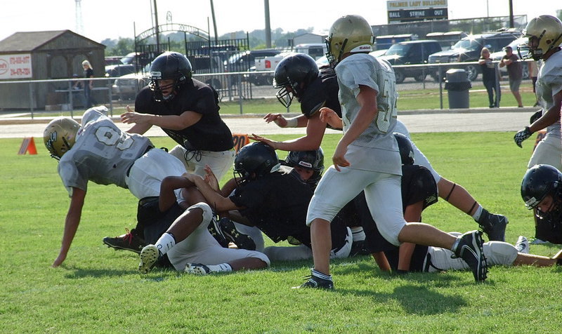 Image: JV Gladiator QB Joe Celis(9) dives for one more yard after leaving 6 Bulldog tacklers in his wake.