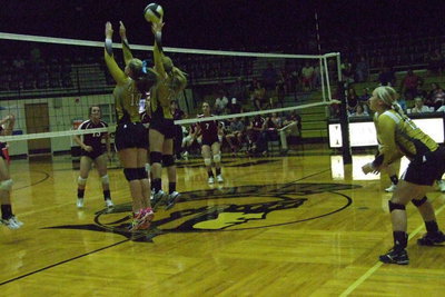 Image: Halee Turner(7) and Madison Washington(10) go for the block at the net with Jaclynn Lewis(13) backing them up.