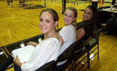 Image: JV Lady Gladiators Jozie Perkins, Hannah Washington and Ashlyn Jacinto help keep the books for the varsity squad.