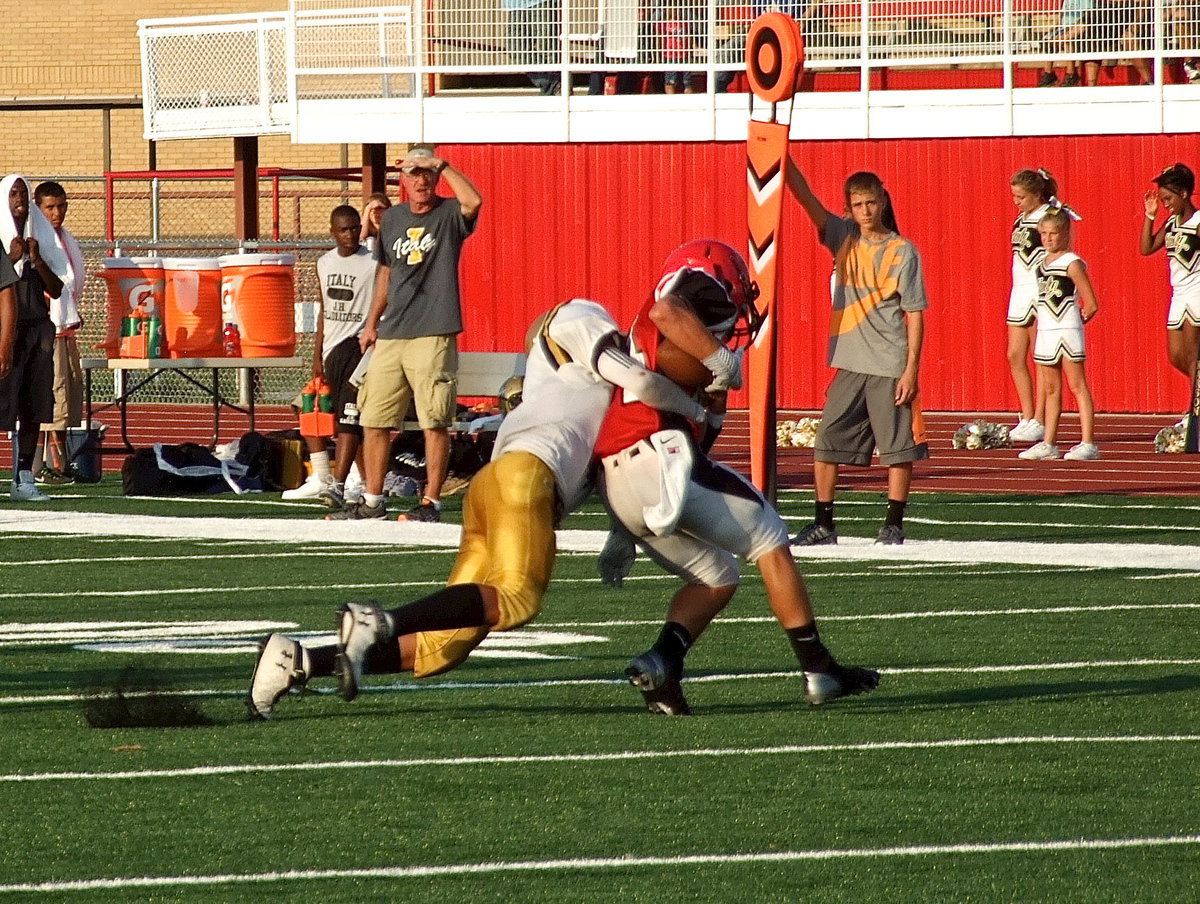 Image: Italy’s Joe Celis(2) drags down a Panther ball carrier.