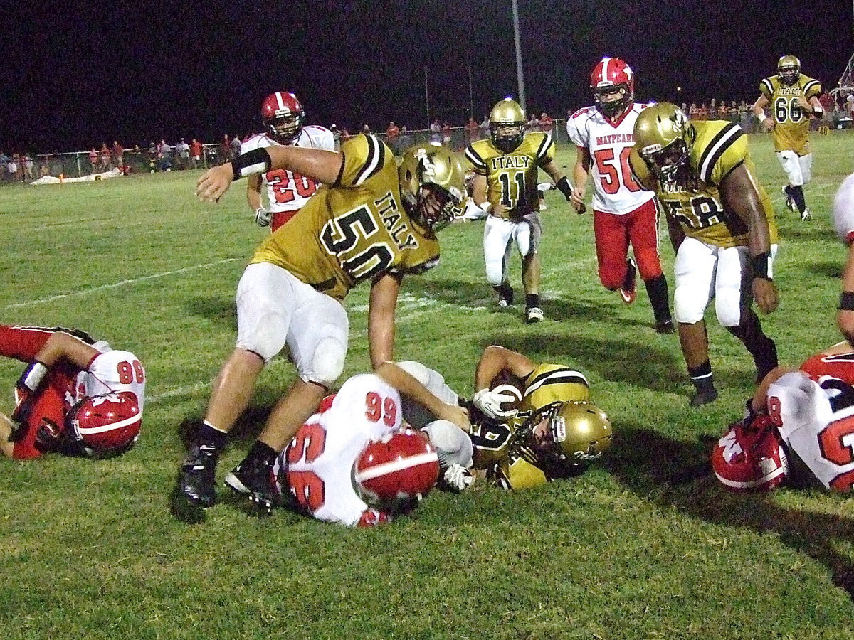 Image: O-linemen Zain Byers(50) and Darol Mayberry(58) clear space for running back Hunter Merimon(9).