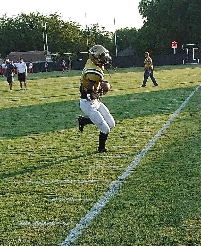 Image: Reciever Trevon Robertson(2) pulls in a sideline pass during pre-game warmups and then does it again later during the game.