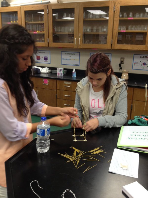 Image: Julissa and Kristian are deep in thought tying the string around marshmallows.