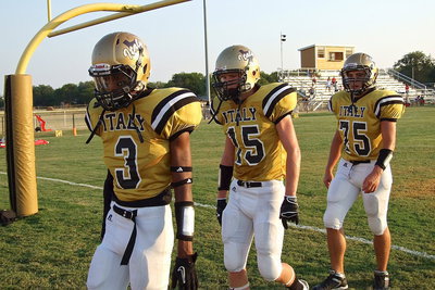 Image: Tre Robertson(3), Cody Boyd(15) and Cody Medrano(75) head into the field house to get their game faces on before taking on visiting Maypearl.