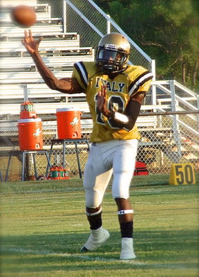 Image: Quarterback TaMarcus Sheppard(10) warms up the new throwing arm of the armor clad Gladiators.